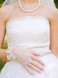 bride hands with ring over the wedding dress