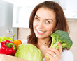 Happy Young Woman with vegetables in shopping bag