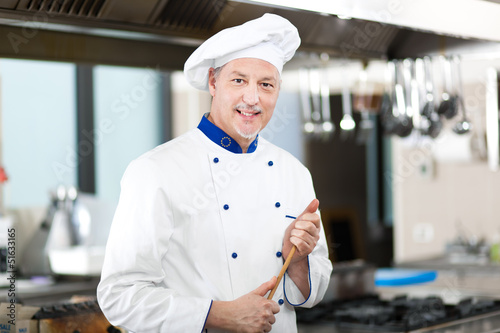 Photo: Male chef working in a restaurant kitchen Male chef working in a restaurant kitchen