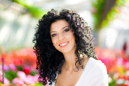 Photo: Smiling female florist in a greenhouse Smiling female florist in a greenhouse