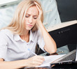 Sad woman looks at the bill