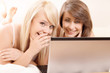  Two beautiful female friends gossiping. Selective focus