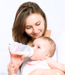 Feeding Baby. Baby eating milk from the bottle