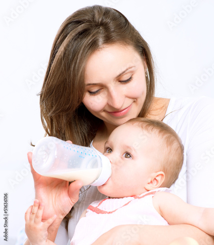 Photo: Feeding Baby. Baby eating milk from the bottle Feeding Baby. Baby eating milk from the bottle
