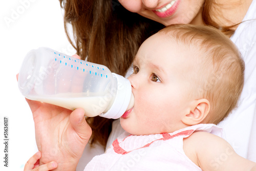 Photo: Feeding Baby. Baby eating milk from the bottle Feeding Baby. Baby eating milk from the bottle