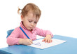 Little scholar writing in the school desk.