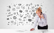 Young businesswoman with all kind of hand-drawn media icons in b