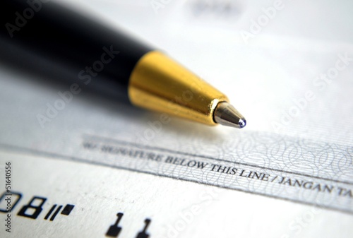 Photo: Close up on cheque with a pen Close up on cheque with a pen
