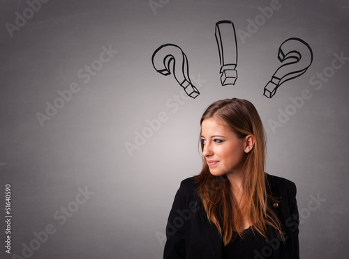 Photo: Young lady thinking with question marks overhead Young lady thinking with question marks overhead