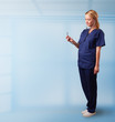 Pretty nurse in hospital listening to empty copy space with sthe