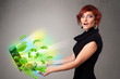 Casual woman holding notebook with recycle and environmental sym