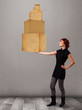 Young lady holding a set of brown cardboard boxes