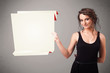 Young woman holding white origami paper copy space