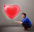 Young man holding lovely 3d red heart