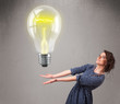 Beautiful lady holding realistic 3d light bulb