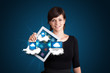 young woman holding tablet with modern devices in clouds
