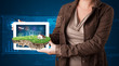 Woman presenting a perfect ecology land with a house and windmil