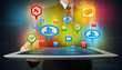Businessman presenting modern tablet with colorful social signs
