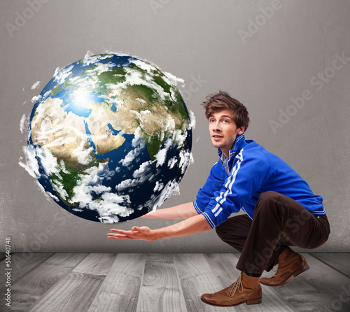 Photo: Good-looking man holding 3d planet earth Good-looking man holding 3d planet earth