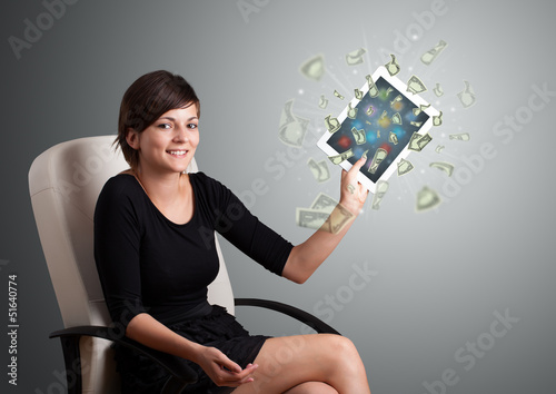 Photo: young woman holding tablet with money young woman holding tablet with money