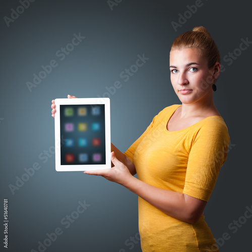 Photo: woman holding modern tablet with colorful icons woman holding modern tablet with colorful icons