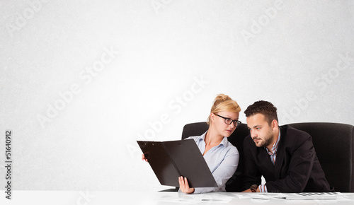 Photo: Businessman and businesswoman with plain white copy space Businessman and businesswoman with plain white copy space