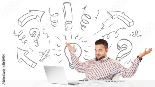 Photo: Young businessman brainstorming with drawn arrows and symbols Young businessman brainstorming with drawn arrows and symbols