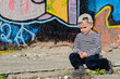 Photo: Small boy sitting thinking or sulking Small boy sitting thinking or sulking