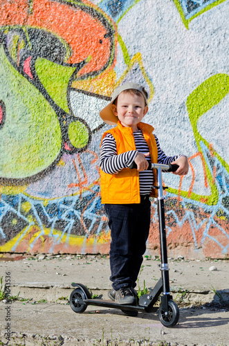 Photo: Proud little boy with his scooter Proud little boy with his scooter