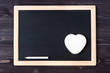 Slate chalk board on wooden background