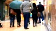 People walking on the street. Out of focus.