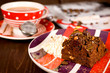 Piece of chocolate cake brownie and a cup of tea