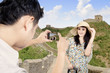 Asian tourist posing in front of the Great Wall China
