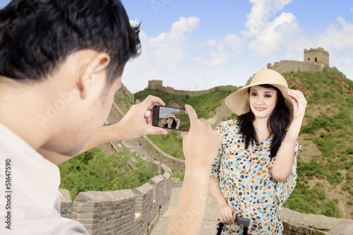 Photo: Asian tourist posing in front of the Great Wall China Asian tourist posing in front of the Great Wall China