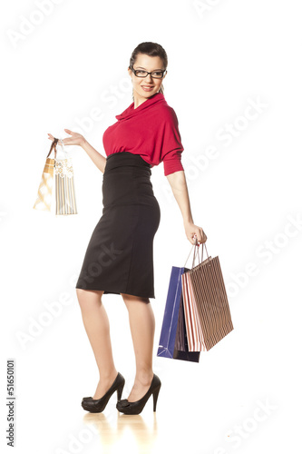 Photo: happy and smiling blue-eyed brunette holding shopping bags happy and smiling blue-eyed brunette holding shopping bags