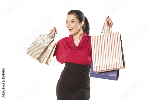 Photo: happy and smiling blue-eyed brunette holding shopping bags happy and smiling blue-eyed brunette holding shopping bags