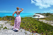 Girl looking along the coastline of Little Exuma, Bahamas