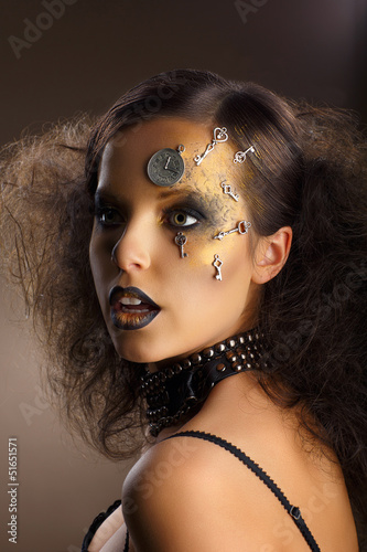 Photo: Futurism. Bodyart. Golden Painted Woman's Skin. Silver Accessory Futurism. Bodyart. Golden Painted Woman's Skin. Silver Accessory