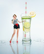 Woman standing with glass beaker of juice