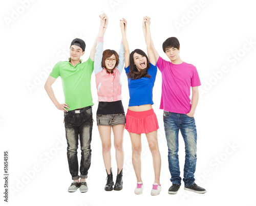 Photo: happy young group standing together with hands up happy young group standing together with hands up