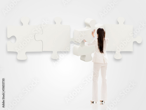 Photo: Business woman with a puzzle Business woman with a puzzle