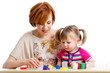 Happy kid girl and mother playing with colorful clay toy