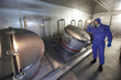 Photo: Technician in mask,with torch, checking tech system Technician in mask,with torch, checking tech system
