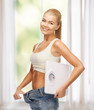 woman showing big pants and holding scales