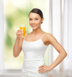 woman holding glass of orange juice