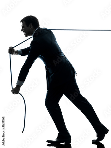 Photo: business man pulling a rope silhouette business man pulling a rope silhouette