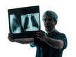 doctor surgeon radiologist surprised  examaning lung torso  x-ra