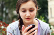 Girl with a mobile phone reads the message