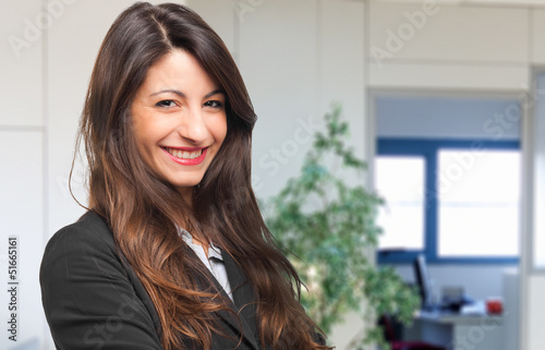 Photo: Happy businesswoman in her office Happy businesswoman in her office