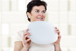 Photo: Woman with blank plate in his hand Woman with blank plate in his hand